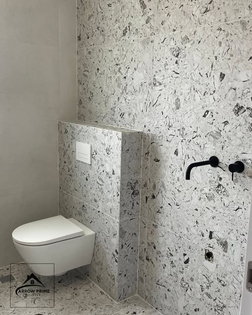 Bathroom design with terrazzo wall and wall-hung toilet