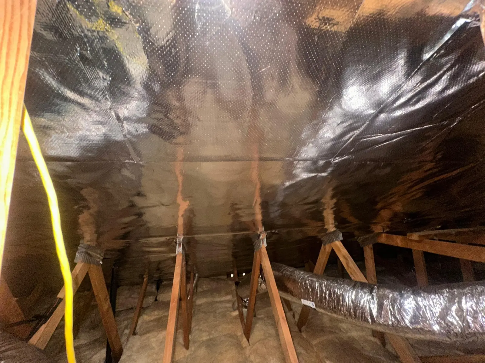 R-38 batts laid between attic joists around a recessed light