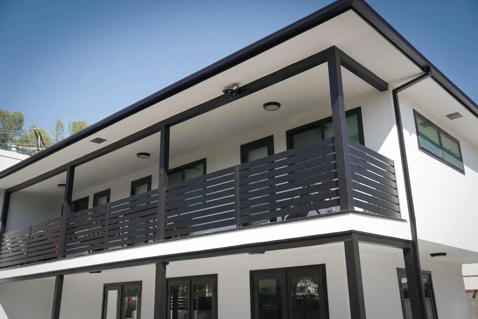 Horizontal slat balcony railing on a modern two-story home