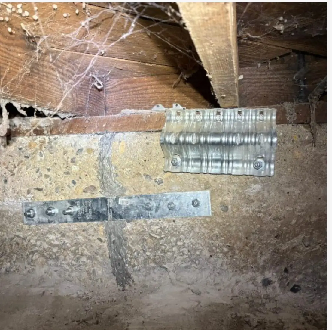 New foundation anchor bolt plate and hold-down strap on a mudsill