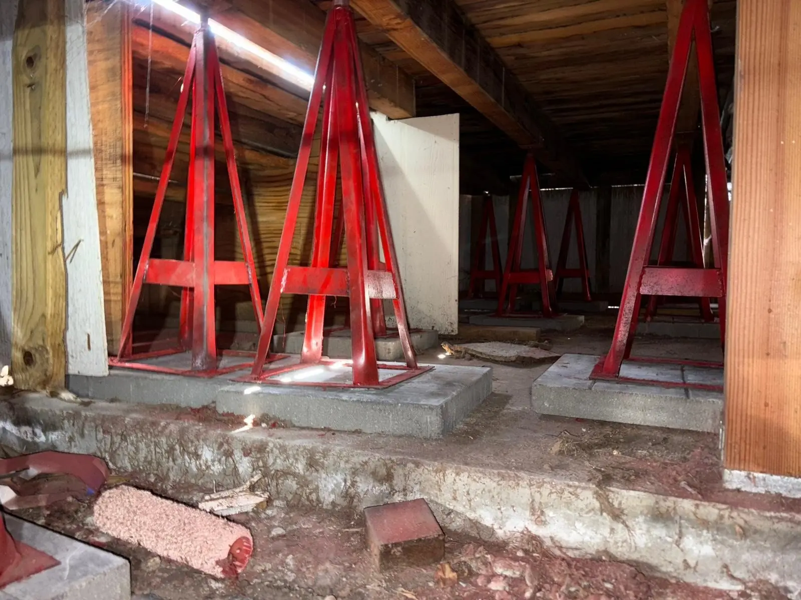 House shored on steel stands during foundation work