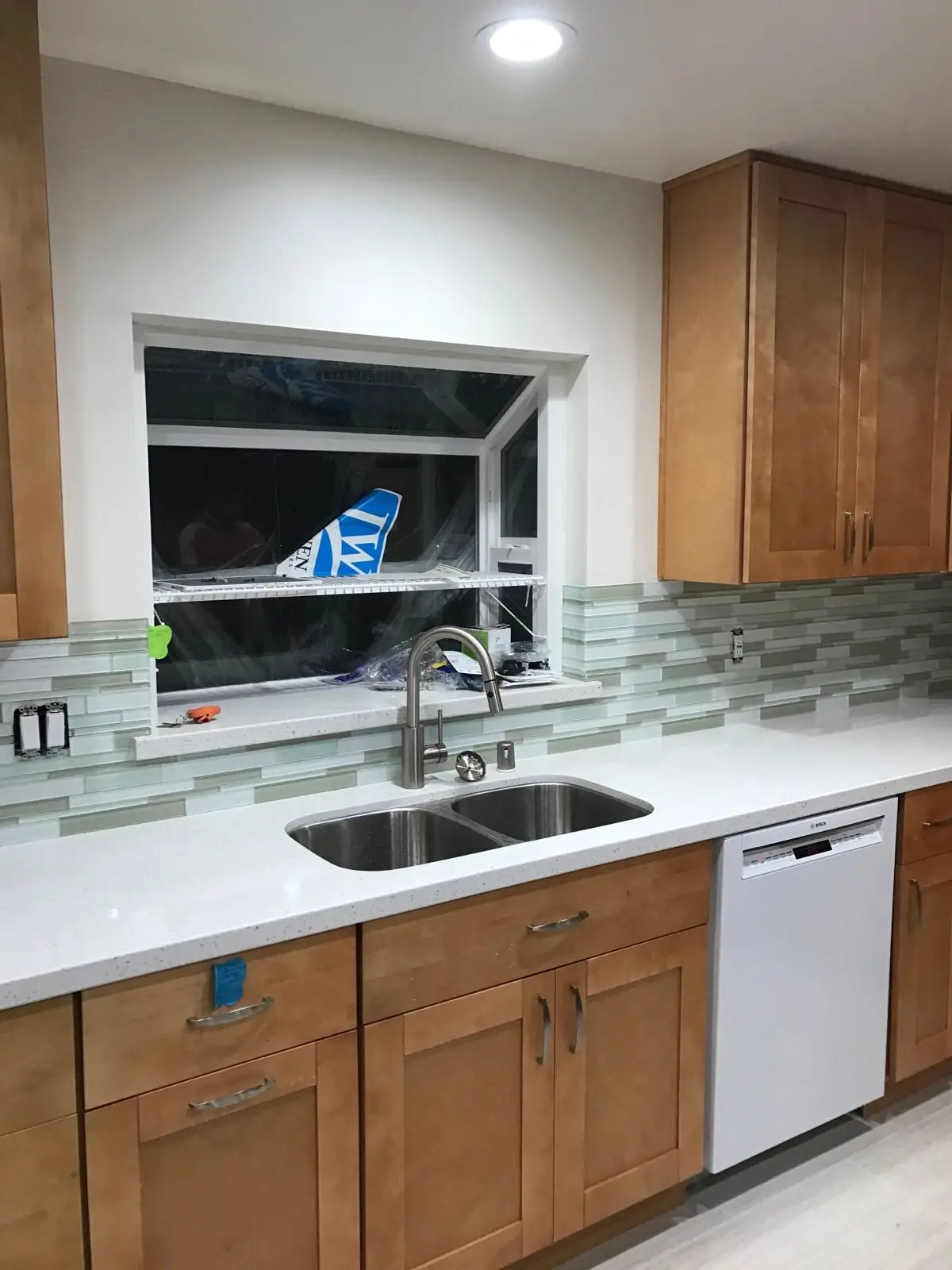 Maple cabinets, undermount sink and glass tile backsplash