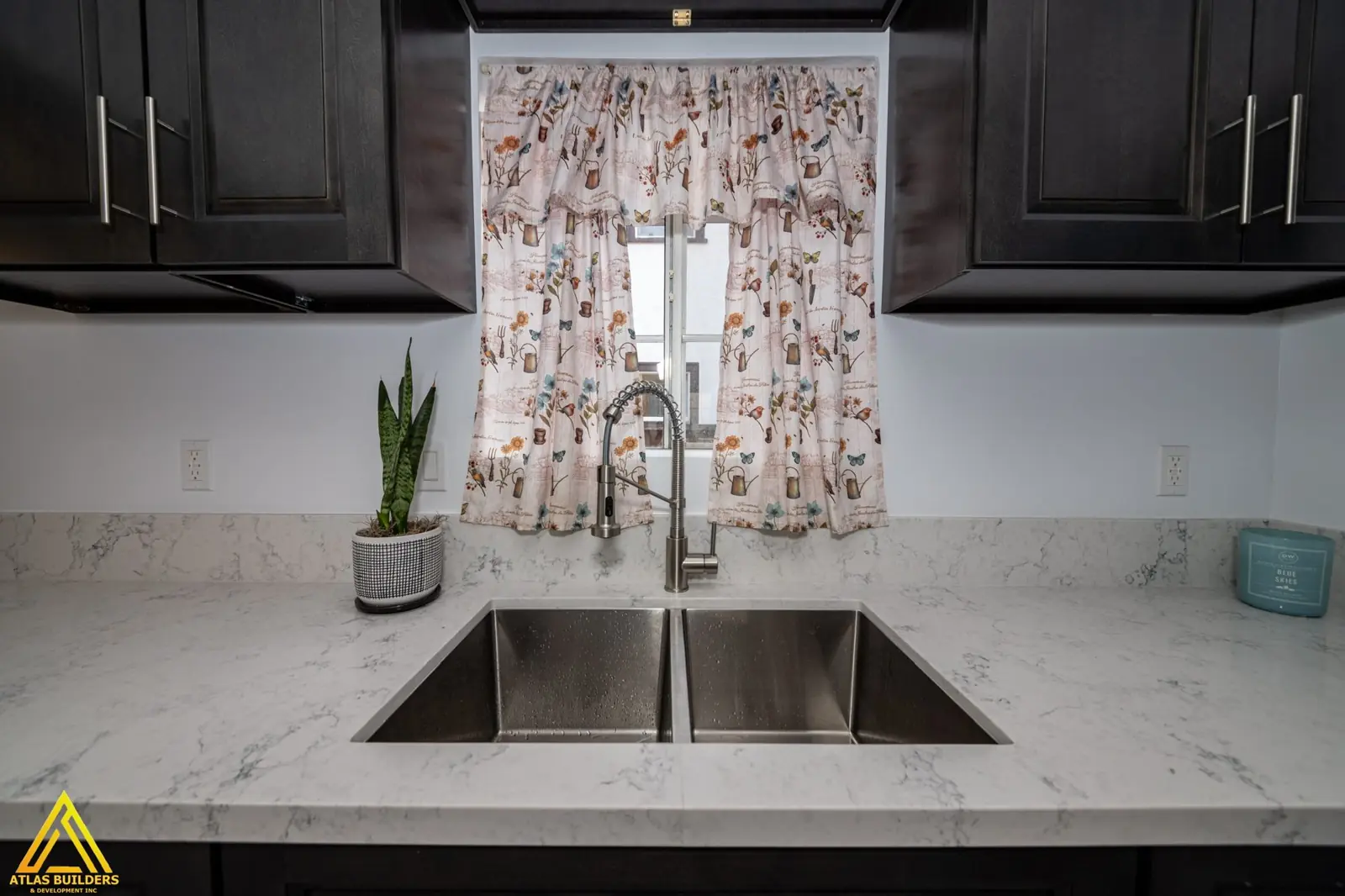 Stainless range hood over a full-height mosaic backsplash