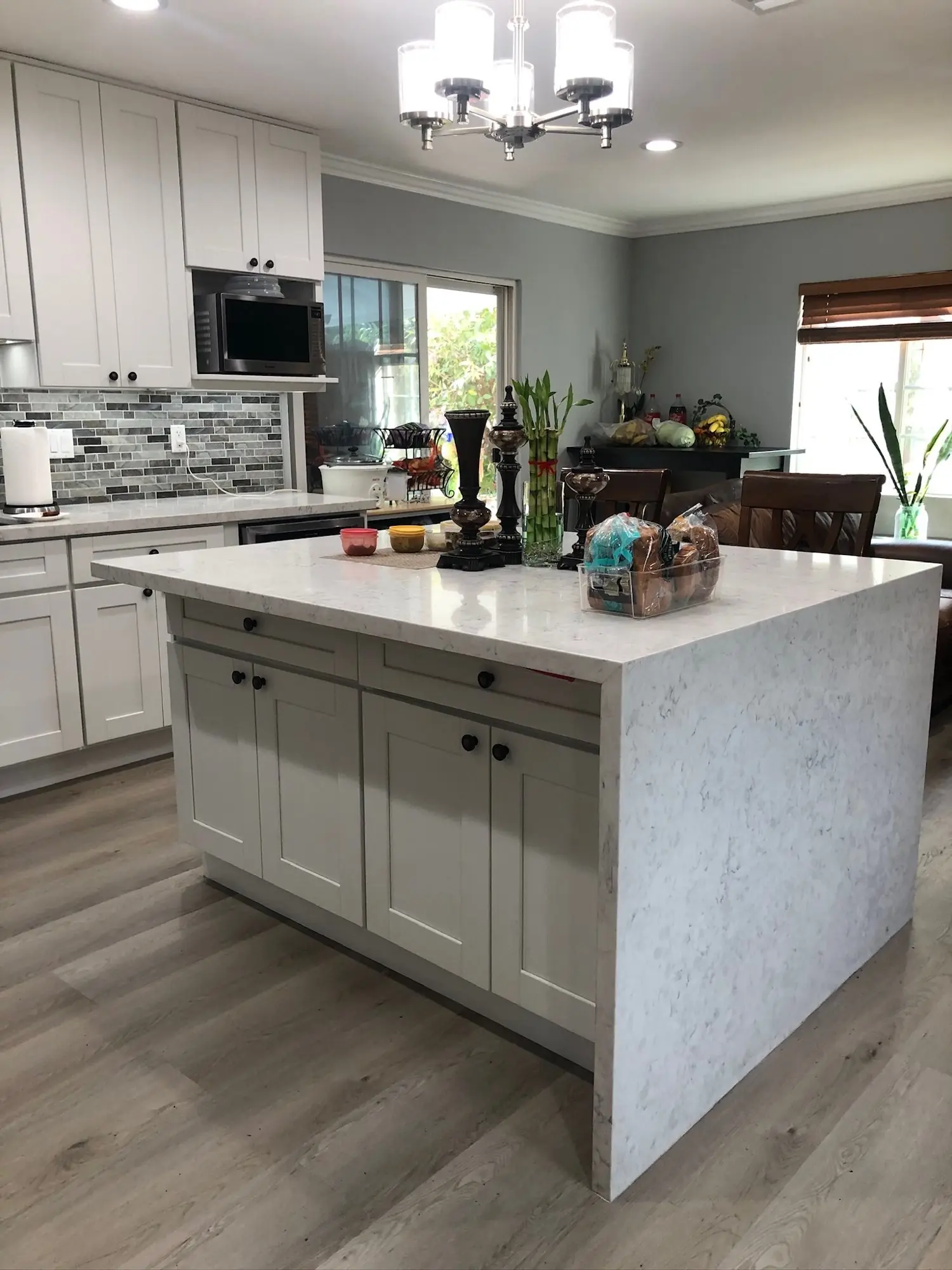 White shaker kitchen with quartz waterfall island
