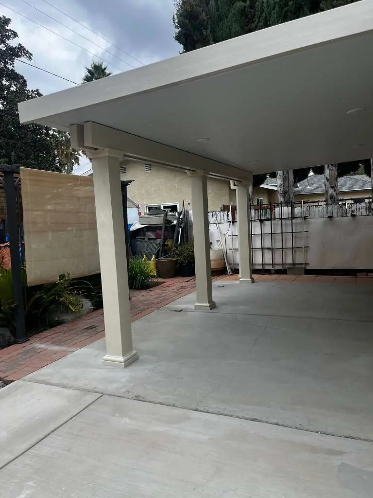 Solid aluminum cover with square columns over a concrete pad