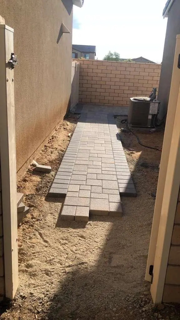 Paver side-yard walkway being laid toward the AC pad