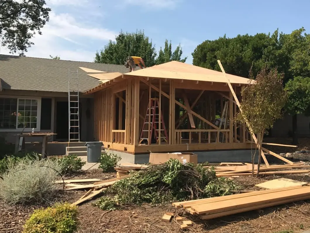 Room addition framing and roof sheathing on a single-story house
