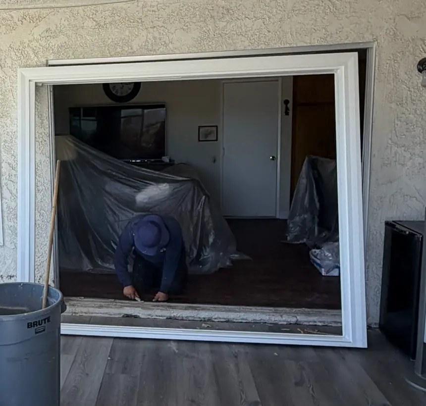 New vinyl patio door frame set into a stucco opening